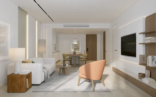 Открытая гостиная с персиковым креслом и телевизором на стене