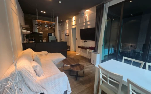 Гостиная с белым текстурированным диваном и кофейными столиками