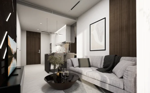 Гостиная с открытой планировкой и серым диваном на фоне кухни