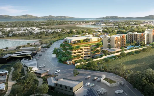 Аэрофотосъемка днем: прибрежные жилые башни с зеленью