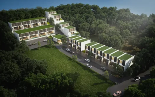 Воздушный дневной вид на террасированный курорт с зелёными крышами