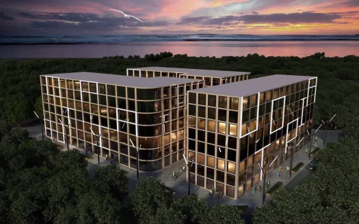 Наружный вид стеклянного офисного комплекса на закате среди деревьев